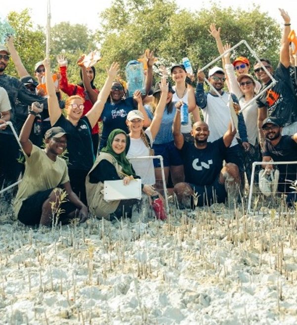 Group of volunteers celebrating together in nature