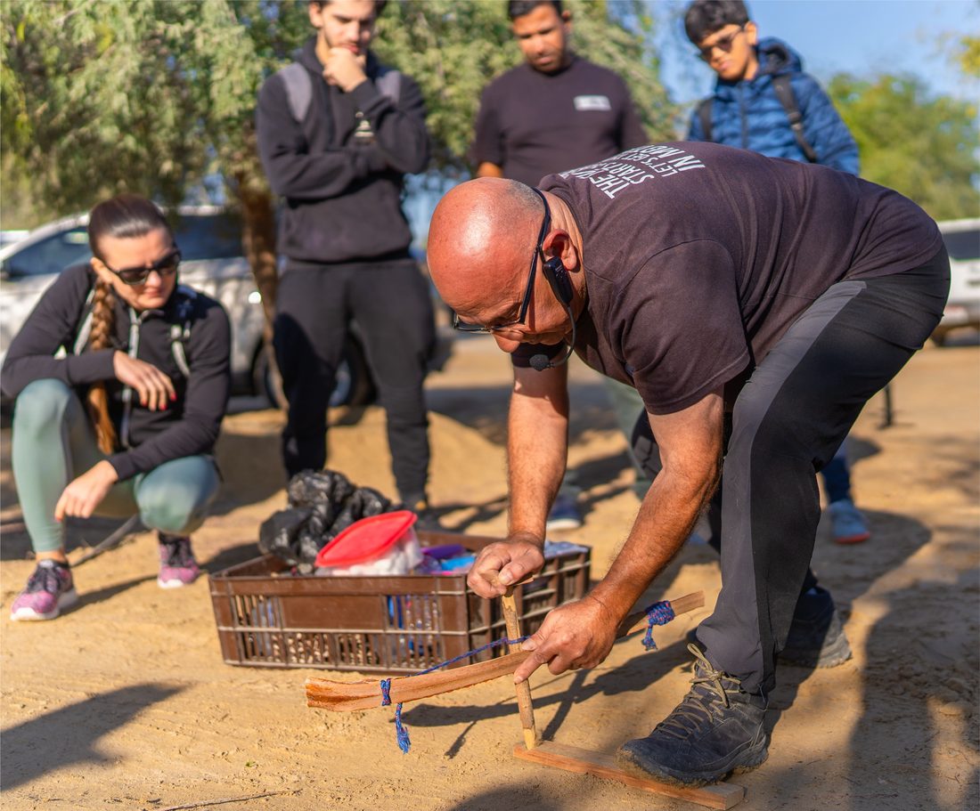 Conservation practitioner demonstrating to participants outdoors