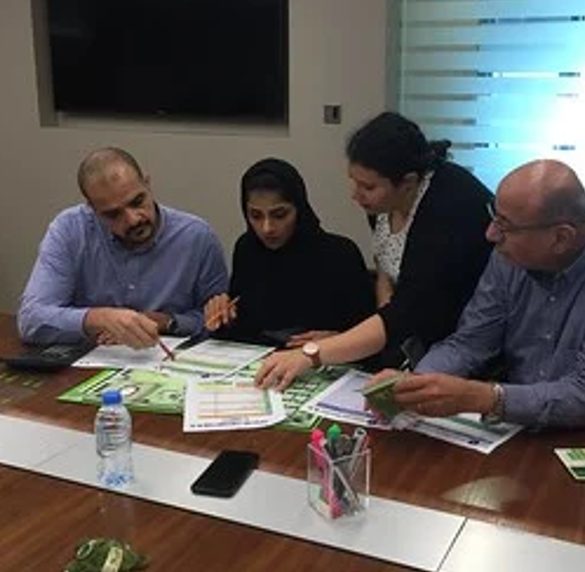 Participants reviewing materials together around a table